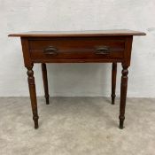A 19th century walnut side table with plank top over a single frieze drawer raised on turned