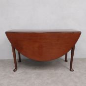 A Georgian mahogany drop flap dining table with gate-leg action on pad foot supports. H.70 W.125 D.