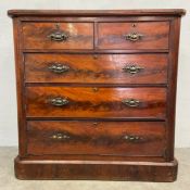 A 19th century mahogany chest of two short over three long figured drawers raised on a plinth