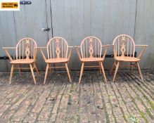 A set of four 1960s Ercol model 878 beech and elm hoop-back windsor armchairs with openwork fleur-