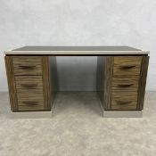 A contemporary twin pedestal desk having a rectangular lacquered top with protective leather sheet