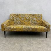 A contemporary mid-century style Hollandez sofa of square angular form with brightly patterned
