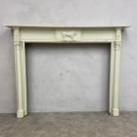 A 19th century carved and painted fire surround with egg-and-dart moulded cornice over the figural