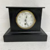A C.1900 French slate mantle clock with enamelled dial bearing stylised Arabic numerals in a