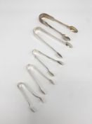 A mixed lot of five Victorian and later 925 sterling silver hallmarked sugar and other tongs by