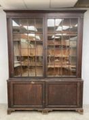 A large 19th century possibly monkey-puzzle wood bookcase with moulded cornice over astragal