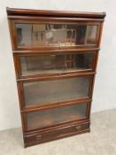An Edwardian mahogany four section barrister bookcase by Globe Wernicke with maker's plaque. H.147