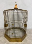 A C.1900 octagonal brass wirework birdcage raised on a plinth base. H.88 W.84 D.84cm.