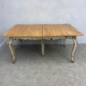 A contemporary French Provincial style extending dining table with distressed painted finish
