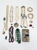 A mixed lot of costume jewellery to include a set of loose baroque pearls and other necklaces,