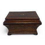 A 19th century inlaid rosewood sewing box of sarcophagus form with a fitted interior raised on bun