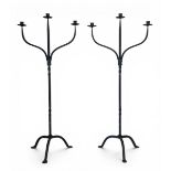 A pair of 19th century Gothic Revival style wrought iron three branch candelabras on splayed