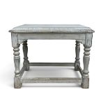 A distressed painted console table in the Jacobean style with plank top on turned stretchered