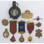 A MKIII 1943 marching compass, a Royal Navy Officer's cap badge, four further cap badges, a silver