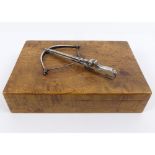 A satinwood cigarette box, mounted with a white metal crossbow to the lid,13.5cm x 9.5cm x 4.5cm.
