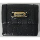 A Gucci designer leather purse. H11cm x W12cm.