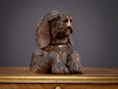 A LATE 19TH CENTURY BLACK FOREST CARVED DOG INKWELL