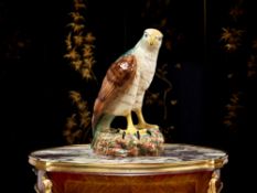 A GLAZED CERAMIC MODEL OF AN EAGLE