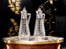 A PAIR OF LATE 19TH CENTURY GERMAN SILVER MOUNTED CLARET JUGS