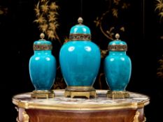 A FINE SET OF THREE 19TH CENTURY FRENCH PORCELAIN AND ORMOLU VASES