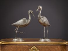 A PAIR OF SILVERED METAL MODELS OF STORKS