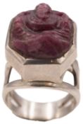 A carved ruby depicting Ganesha, in a silver ring.