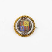 A 1887 Queen Victoria Jubilee silver sixpence in a yellow metal frame.