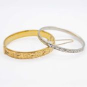 One silver bangle and one 9k gold metal cored bangle.