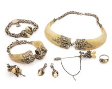 A selection of German silver boar tusk and deer tooth set jewellery items.