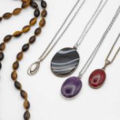 A selection of five silver and gemstone necklaces.
