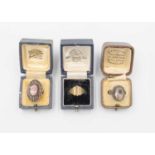 An Arts & Crafts rose quartz set silver ring, a carnelian set silver ring and a base signet ring.