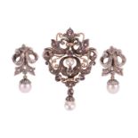 A cultured pearl and diamond brooch cum pendant and pair of similar earrings; The pendant of