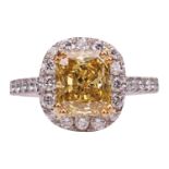 A yellow diamond halo ring, the central radiant-cut diamond with an estimated weight of 2.15ct, in a