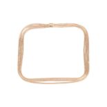 A textured necklace, comprising four rows of graduated length each with bark textured links, with