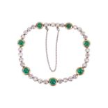 An early 20th Century emerald and diamond bracelet, set with seven cabochon and sugarloaf