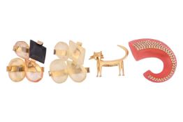 A cat brooch in gilt metal by Jean Coctaeu, together with a pair of glass and gilt metal brooches by