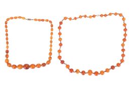 Two reconstituted amber bead necklaces; the first containing a strand of graduated round reconstitut