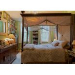 A MAHOGANY FOUR POSTER BED FRAME WITH FLUTED TURNED PILLARS AND DRAPES