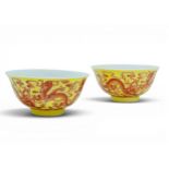 A PAIR OF EXTREMELY RARE YELLOW-GROUND AND IRON-RED 'DRAGON' BOWLS QIANLONG SEAL MARK AND OF THE