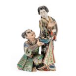 A LARGE JAPNESE KUTANI GROUP MEIJI PERIOD (1868-1912)  depicting a Bijin and a kneeling samurai,