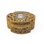 A FANCY GILT BRASS RETICULATED BOX of canted oval form pierced with fancy foliate engraved and