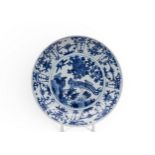 A CHINESE MING-STYLE BLUE AND WHITE DISH QING OR LATER painted in tones of underglaze blue with a