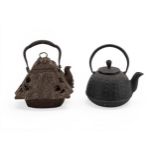 TWO JAPANESE IRON TEAPOTS, TESUBIN LATE MEIJI / TAISHO PERIOD  one modelled as a samurai helmet, the
