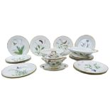 A LIMOGES PART DINNER SERVICE 19TH CENTURY painted with butterflies among flowering grasses, herbs
