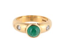 AN EMERALD AND DIAMOND THREE STONE RING