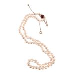 A CULTURED PEARL NECKLACE WITH RUBY AND DIAMOND THREE STONE CLASP