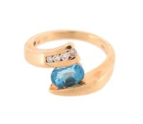 A BLUE TOPAZ AND DIAMOND CROSSOVER RING