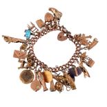 A 9CT GOLD CHARM BRACELET
