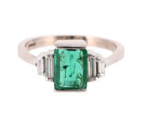 AN EMERALD AND DIAMOND FIVE STONE RING