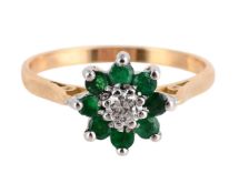 AN EMERALD AND DIAMOND CLUSTER RING